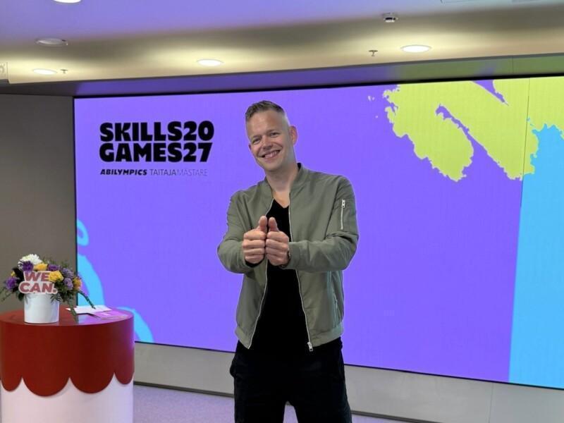 Signmark showing the sign "together" on colourful background with Skills Games logo.